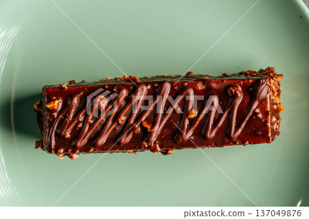 Chocolate glazed cake bar with nuts Chocolate glazed cake bar with nuts 137049876