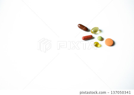 Different multicolored pills, tablets, vitamins, capsules isolated on white background. Pharmaceutical industry, healthcare and medicine. Different multicolored pills, tablets, vitamins, capsules isolated on white background. Pharmaceutical industry, healthcare and medicine. 137050341