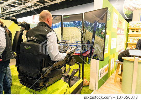 Agricultural technician operating advanced machinery with digital displays Agricultural technician operating advanced machinery with digital displays 137050378
