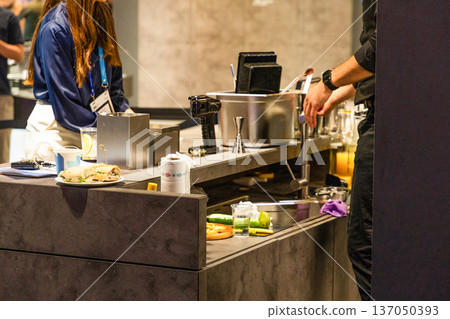 Bartender preparing drinks at modern bar with fresh ingredients 137050393