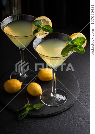 Elegant cocktail two glasses of limoncello spritz, garnished with fresh lemon slices and mint sprigs Elegant cocktail two glasses of limoncello spritz, garnished with fresh lemon slices and mint sprigs 137050481