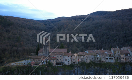 Castellfollit de la Roca on Basalt Cliff in Catalonia Castellfollit de la Roca on Basalt Cliff in Catalonia 137050486