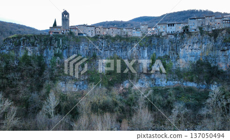 Castellfollit de la Roca on Basalt Cliff in Catalonia Castellfollit de la Roca on Basalt Cliff in Catalonia 137050494