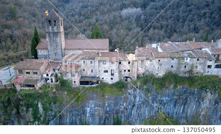 Castellfollit de la Roca on Basalt Cliff in Catalonia Castellfollit de la Roca on Basalt Cliff in Catalonia 137050495
