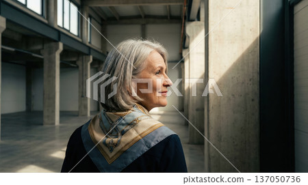 Elegant mature woman in spacious industrial interior 137050736
