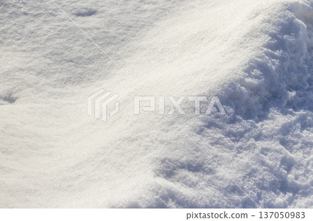 Animal tracks left in deep snow. 137050983