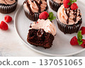 Raspberry chocolate cupcakes with fresh raspberries and chocolate sauce for Valentines Day 137051065