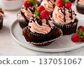 Raspberry chocolate cupcakes with fresh raspberries and chocolate sauce for Valentines Day 137051067