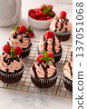 Raspberry chocolate cupcakes with fresh raspberries and chocolate sauce 137051068