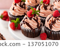 Raspberry chocolate cupcakes with fresh raspberries and chocolate sauce 137051070