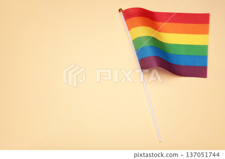 LGBT rainbow flag flat lay on beige background. Space for text LGBT rainbow flag flat lay on beige background. Space for text 137051744