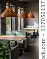 Stylish modern restaurant interior with cozy seating and natural light from large windows 137052137