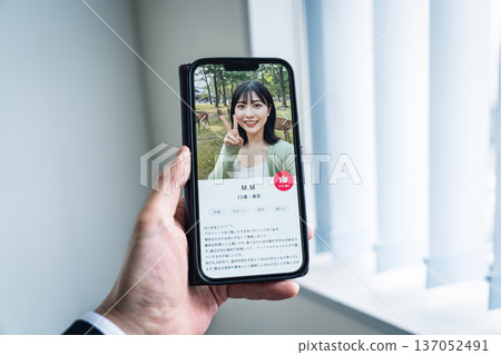 一名男子正在使用約會應用程式尋找結婚伴侶。 一名男子正在使用約會應用程式尋找結婚伴侶。 137052491