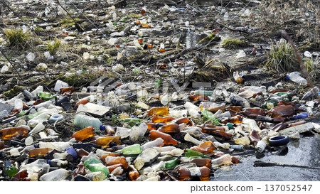 Dirty river is polluted with many plastic bottles. A lot of trash is dumped in open and freely available places at nature. Global environmental pollution problem. Concept of ecological disaster Dirty river is polluted with many plastic bottles. A lot of trash is dumped in open and freely available places at nature. Global environmental pollution problem. Concept of ecological disaster 137052547