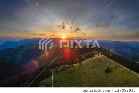 Old peasant home on hillside. Amazing mountain landscape. Bright colorful sunset in wild national park highlands. Dark spruce woods illuminated with yellow setting sun Old peasant home on hillside. Amazing mountain landscape. Bright colorful sunset in wild national park highlands. Dark spruce woods illuminated with yellow setting sun 137052933