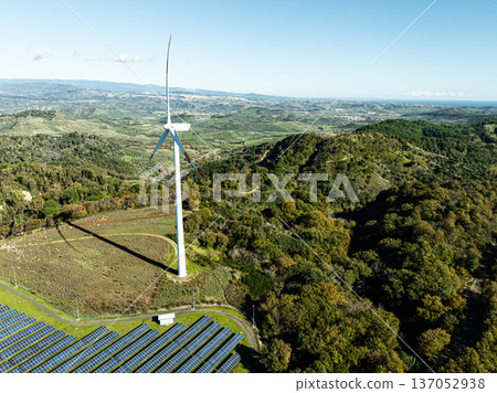 Wind turbine spins and produces energy Wind turbine spins and produces energy 137052938