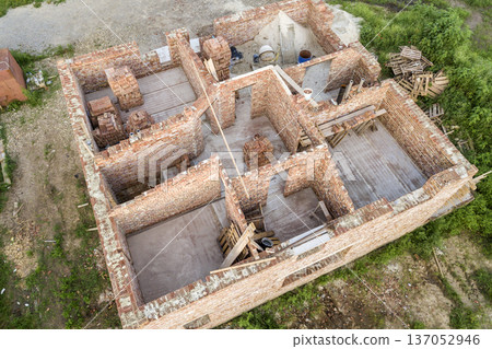 Aerial view of building site for future house, brick basement floor and stacks of brick for construction. 137052946