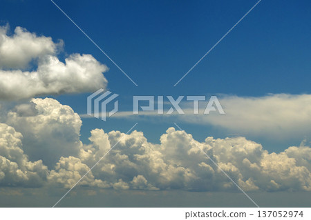 Bright landscape of blue sky with flying white clouds. Colorful summer skyscape 137052974