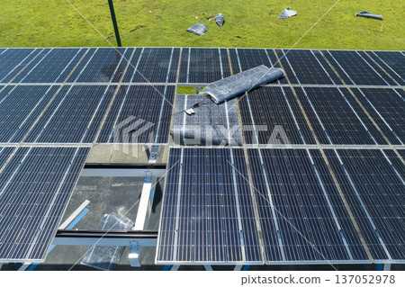 Destroyed by hurricane wind solar panels installed over parking lot canopy shade for parked cars for effective generation of clean energy. Damage from severe weather to Florida infrastructure Destroyed by hurricane wind solar panels installed over parking lot canopy shade for parked cars for effective generation of clean energy. Damage from severe weather to Florida infrastructure 137052978