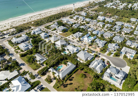 Expensive waterfront houses between green palm trees in Boca Grande, small town on Gasparilla Island in southwest Florida. Premium housing development in the USA 137052995