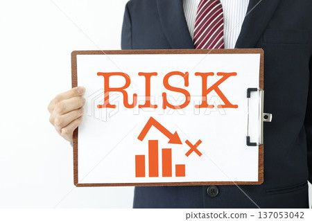 Warning concept of businessman showing falling graph and RISK. Warning concept of businessman showing falling graph and RISK. 137053042