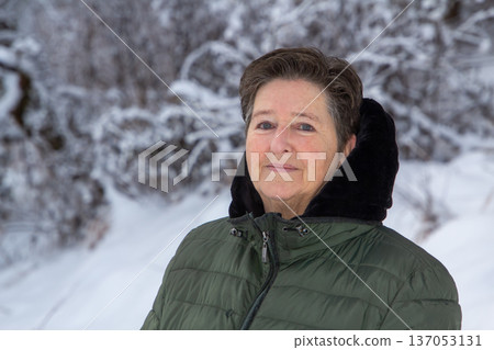 Woman walking in the snowy mountains looking at the camera Woman walking in the snowy mountains looking at the camera 137053131