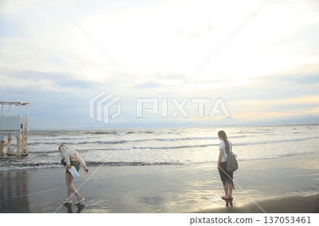 A girl playing on the beach at dusk A girl playing on the beach at dusk 137053461