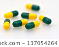 Green and yellow Tramadol capsule pills isolated on white background. 137054264