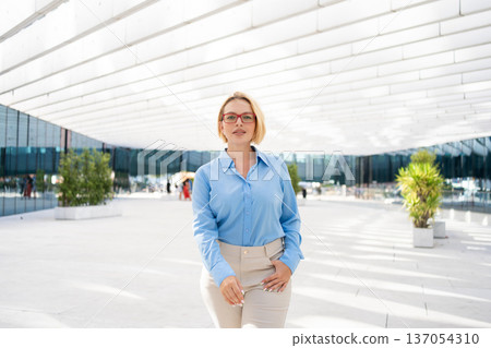 Confident businesswoman standing in front of 137054310