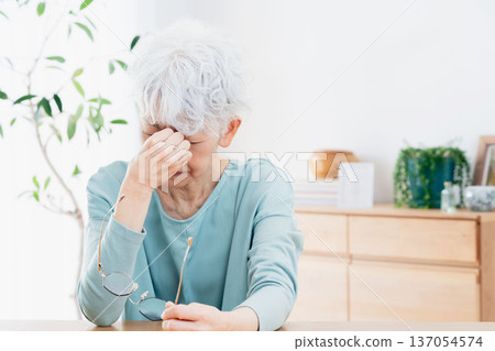 Senior women suffering from tired eyes 137054574