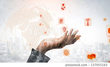 Conceptual hand reaching out with digital icons representing technology, communication, and globalization against a blurred urban background xenic 137055283