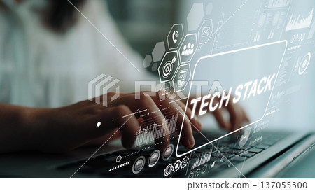 Hands Typing on Laptop with Digital Overlay Displaying Tech Stack Concept and Data Graphics in Modern Workspace. Asymptotic smart data analytic Hands Typing on Laptop with Digital Overlay Displaying Tech Stack Concept and Data Graphics in Modern Workspace. Asymptotic smart data analytic 137055300