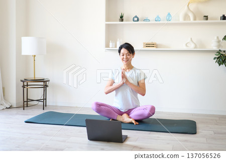 Yoga instructor giving online lectures Yoga instructor giving online lectures 137056526