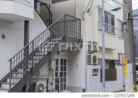 Apartment exterior with exterior stairs, residential area Apartment exterior with exterior stairs, residential area 137057266
