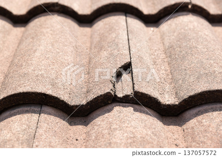 Damaged old roof tile in need of repair. Damaged old roof tile in need of repair. 137057572