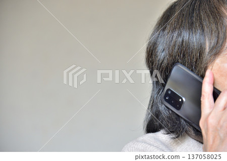 Senior woman talking on a mobile phone Senior woman talking on a mobile phone 137058025