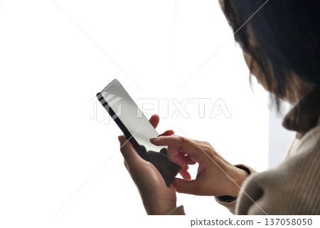 Senior woman operating mobile phone 137058050