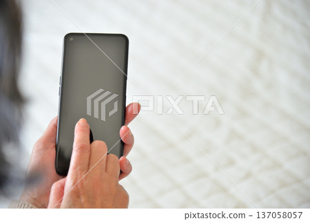 Senior woman operating mobile phone Senior woman operating mobile phone 137058057
