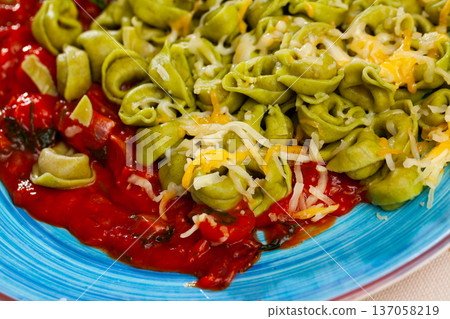 Italian spinach tortellini pasta with tomato sauce 137058219