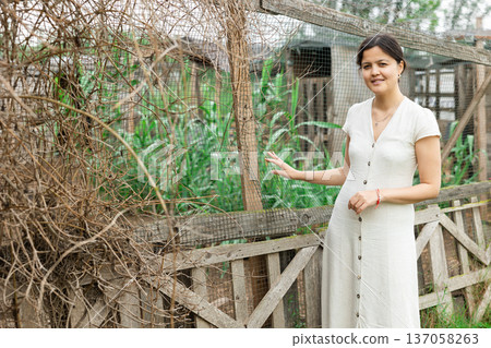 Portrait of young pretty woman farmer smiling on sunny summer morning. 137058263