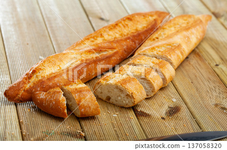 Image of cut crunchy homemade baked fresh baguettes 137058320
