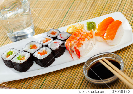 Various of nigiri and hosomaki sushi traditionally served with wasabi and soy sauce Various of nigiri and hosomaki sushi traditionally served with wasabi and soy sauce 137058330