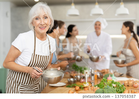 Mature woman holding bowl in her hands 137058387
