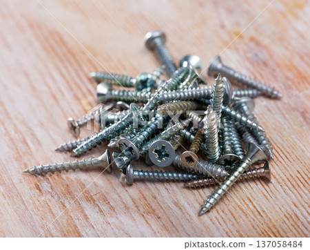 Closeup of golden, silver and black screws Closeup of golden, silver and black screws 137058484