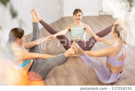 Three women doing group pose in fitness studio Three women doing group pose in fitness studio 137058538
