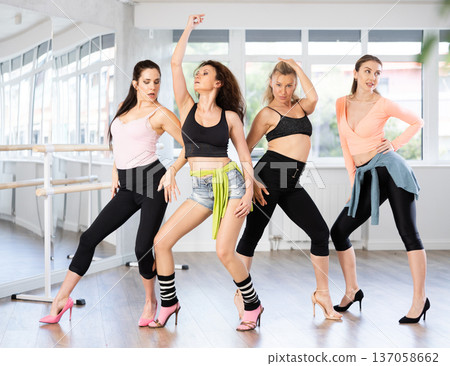 Group of women in high heels posing in studio Group of women in high heels posing in studio 137058662
