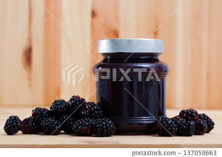 Closed glass jar of blackberry jam 137058663