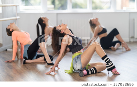 Female dancer in high heels performing contemporary dance on floor 137058696