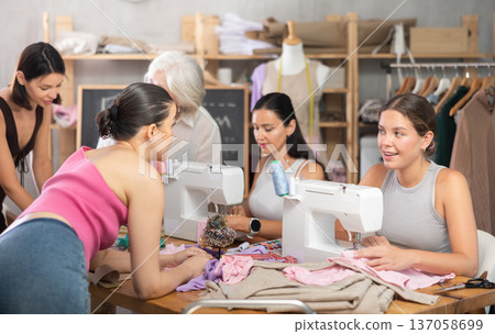 Group of women sewing, drawing and communicating at dressmaking courses 137058699