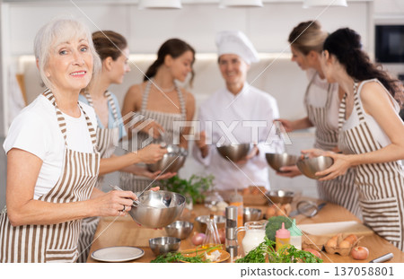 Mature woman holding bowl in her hands Mature woman holding bowl in her hands 137058801